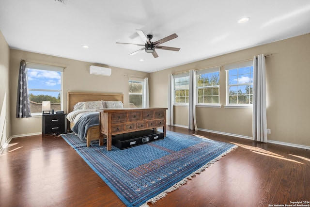 bedroom featuring ceiling fan, an AC wall unit, recessed lighting, baseboards, and wood finished floors