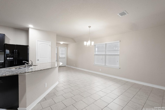 kitchen featuring visible vents, a sink, black refrigerator with ice dispenser, an inviting chandelier, and light tile patterned flooring