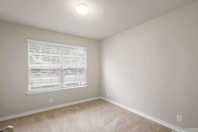 unfurnished room featuring baseboards and carpet floors