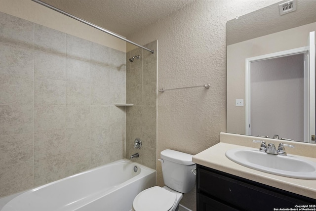 full bathroom with a textured ceiling, visible vents, vanity, toilet, and a textured wall