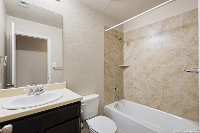 bathroom with visible vents, a textured ceiling, a textured wall, and vanity