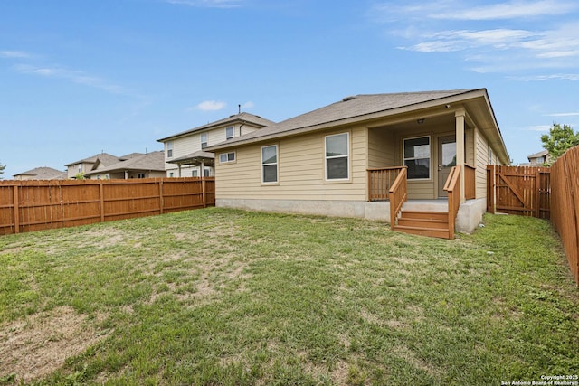 back of property featuring a yard and a fenced backyard