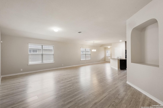 unfurnished living room with recessed lighting, baseboards, visible vents, and light wood-type flooring