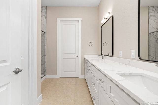 full bath with baseboards, a sink, an enclosed shower, and double vanity