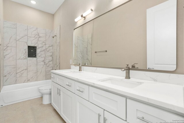 bathroom featuring a sink, shower / bathing tub combination, toilet, and double vanity