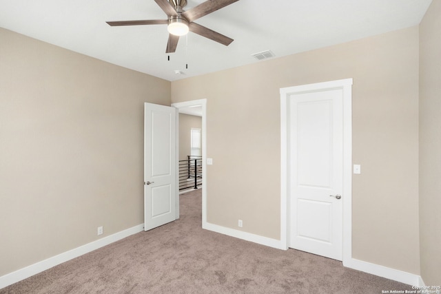 unfurnished bedroom with a ceiling fan, baseboards, visible vents, and light carpet