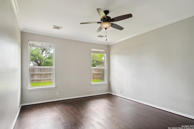 empty room featuring crown molding, ceiling fan, dark wood-style flooring, and visible vents