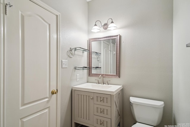 bathroom featuring toilet and vanity