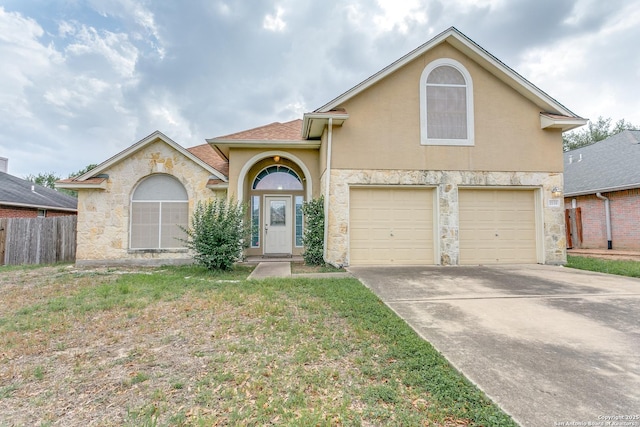 view of front of house with fence, an attached garage, a front lawn, stucco siding, and concrete driveway