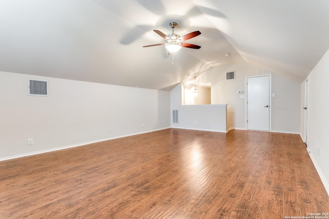 additional living space featuring ceiling fan, visible vents, wood finished floors, and vaulted ceiling