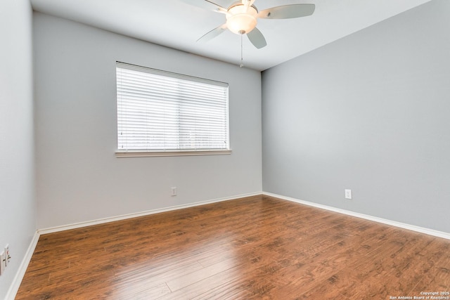 spare room featuring baseboards, ceiling fan, and wood finished floors