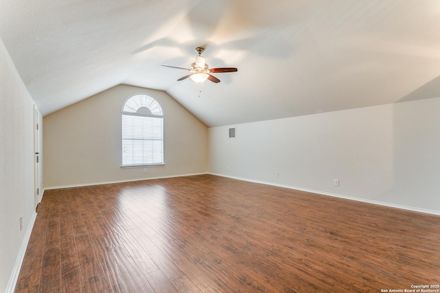 bonus room with baseboards, a ceiling fan, dark wood-style flooring, and lofted ceiling