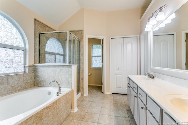 bathroom with double vanity, a sink, a bath, and a stall shower