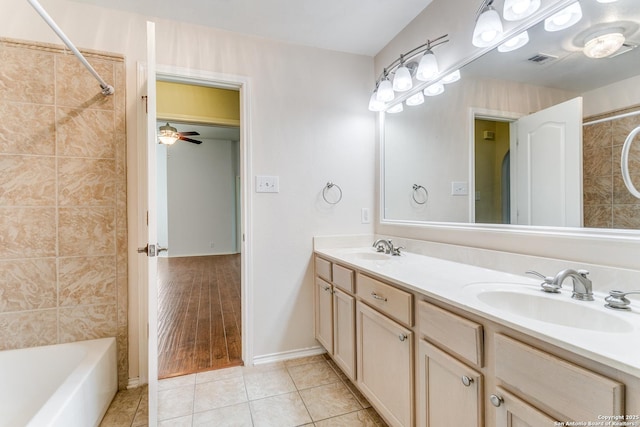 bathroom featuring double vanity, tile patterned floors, visible vents, and a sink