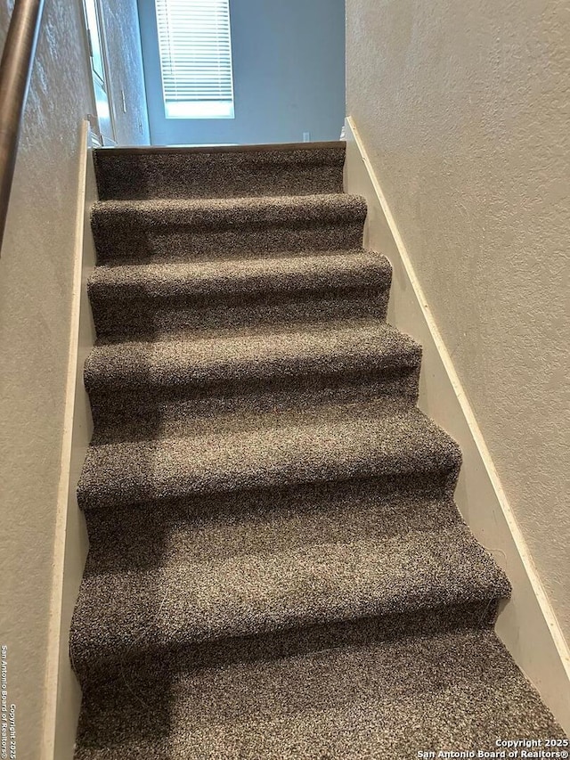 stairs with a textured wall