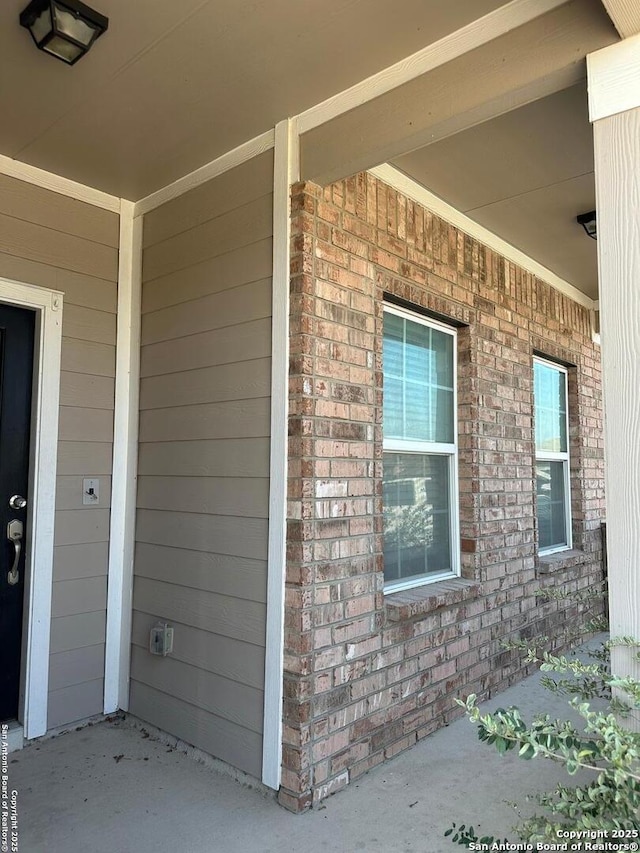 entrance to property with brick siding