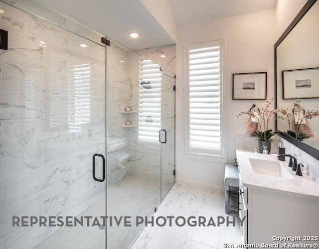 bathroom with baseboards, vanity, marble finish floor, a marble finish shower, and recessed lighting