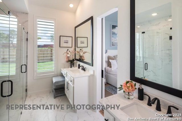 bathroom with vanity, marble finish floor, baseboards, and a marble finish shower