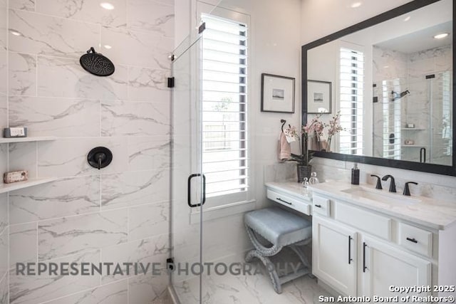 bathroom with vanity, marble finish floor, and a shower stall