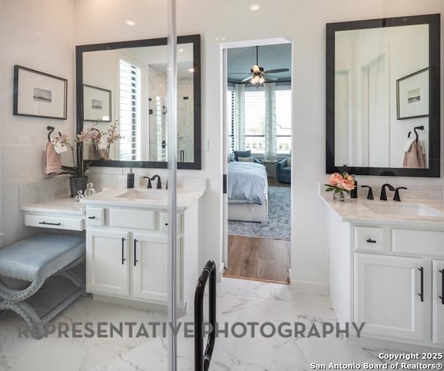 bathroom with a sink, ceiling fan, marble finish floor, and connected bathroom