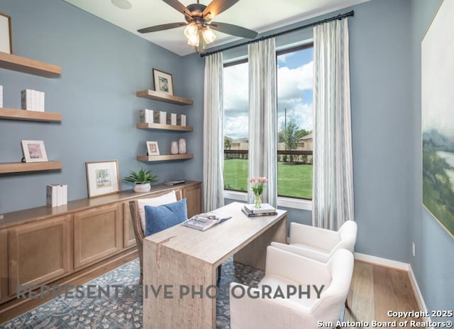 office area with ceiling fan, baseboards, plenty of natural light, and wood finished floors