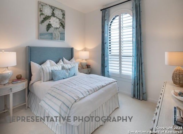 carpeted bedroom featuring baseboards