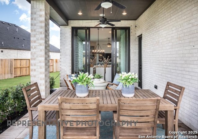 view of patio / terrace featuring a fenced backyard, a ceiling fan, and outdoor dining area