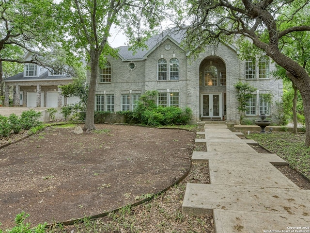 109A Ammann, Boerne, TX 78015 - view of front of home with brick siding, a garage, french doors, and driveway