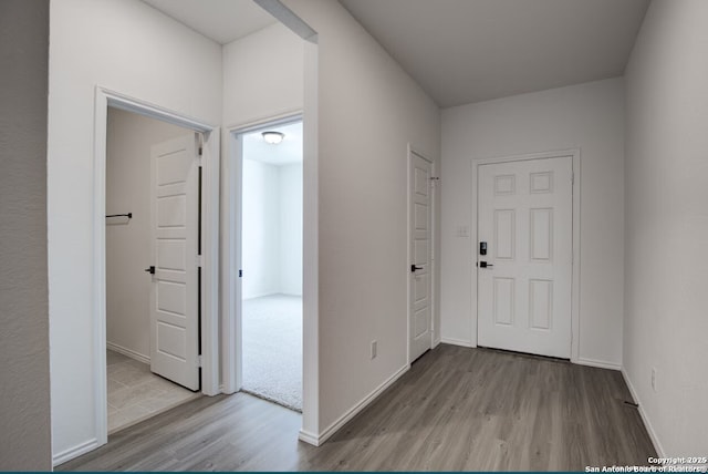 entryway featuring baseboards and wood finished floors