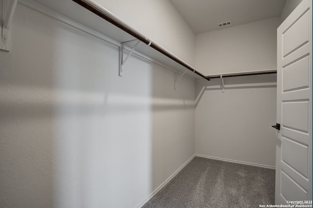 spacious closet featuring visible vents and carpet