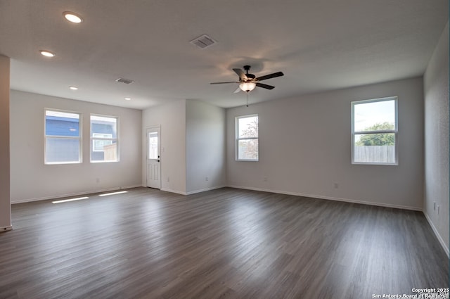 empty room with recessed lighting, baseboards, a ceiling fan, visible vents, and dark wood-style floors