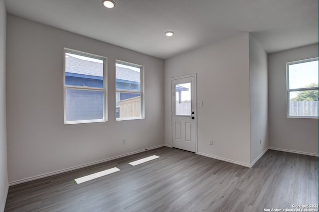 foyer entrance featuring recessed lighting, baseboards, plenty of natural light, and wood finished floors
