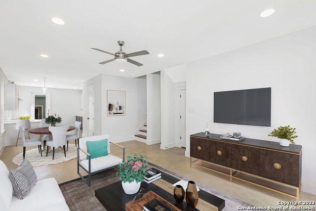 living room featuring recessed lighting, stairs, ceiling fan, and baseboards