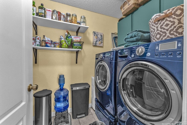 laundry room with independent washer and dryer, a textured ceiling, laundry area, and tile patterned floors