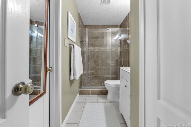 full bath with tile patterned flooring, a textured ceiling, a stall shower, and vanity
