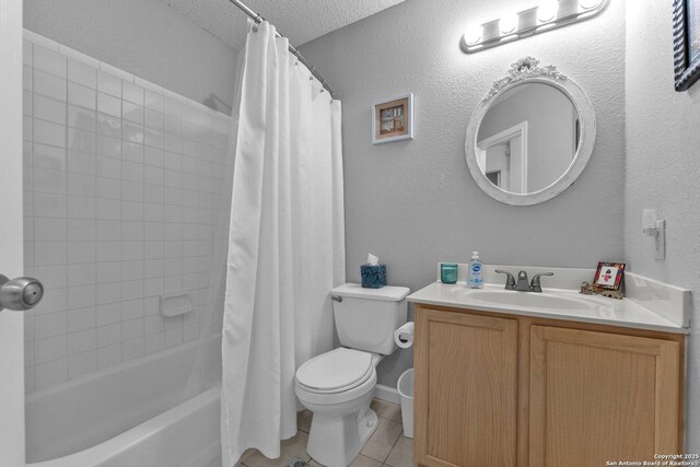 full bath featuring vanity, toilet, tile patterned floors, a textured ceiling, and shower / tub combo