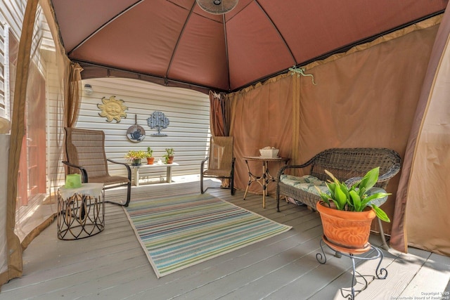 wooden terrace featuring a gazebo