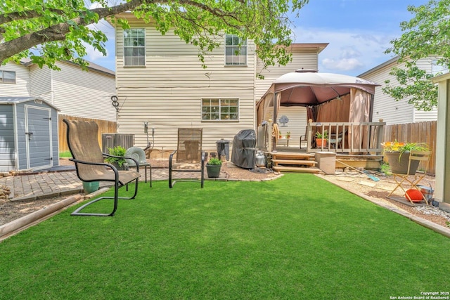 back of property featuring a gazebo, fence, an outdoor structure, and a storage unit