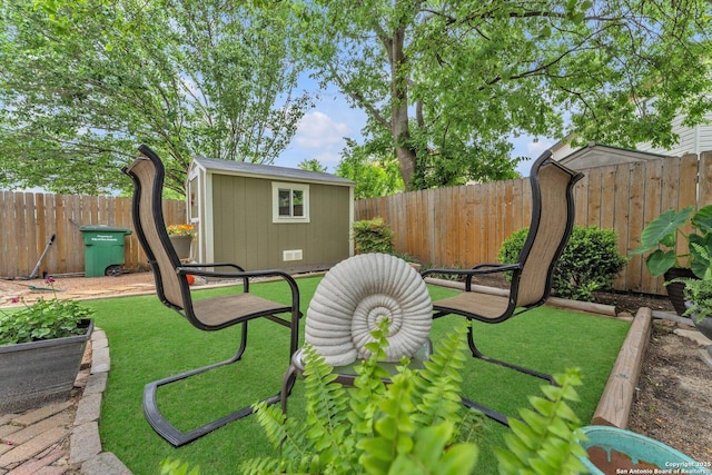 view of yard featuring an outbuilding, a fenced backyard, and a shed