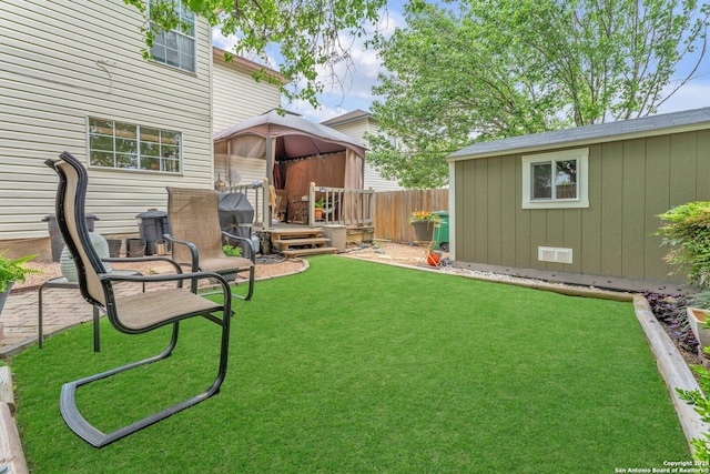 view of yard with fence and an outdoor structure