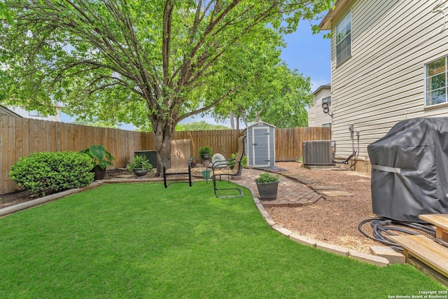 view of yard featuring cooling unit, an outbuilding, a shed, and a fenced backyard
