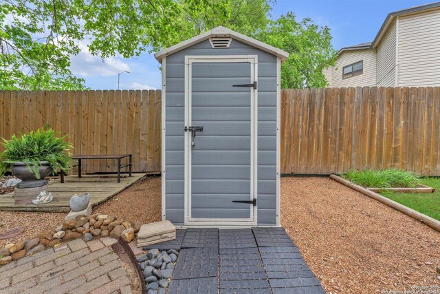 view of shed featuring fence