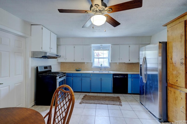 kitchen featuring blue cabinetry, appliances with stainless steel finishes, a sink, light countertops, and under cabinet range hood