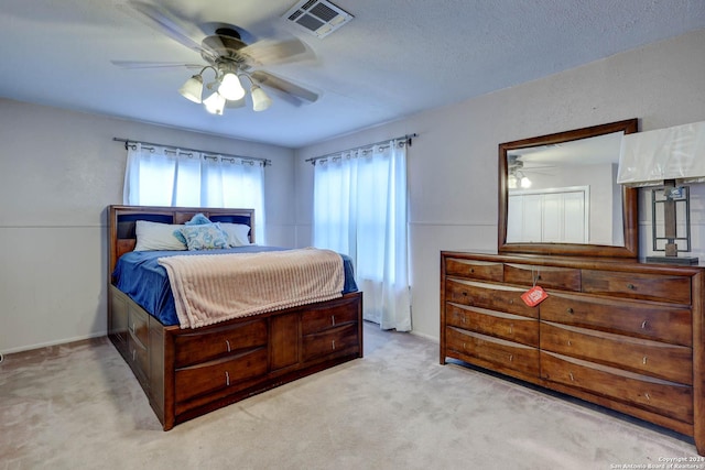 bedroom featuring ceiling fan, visible vents, and carpet
