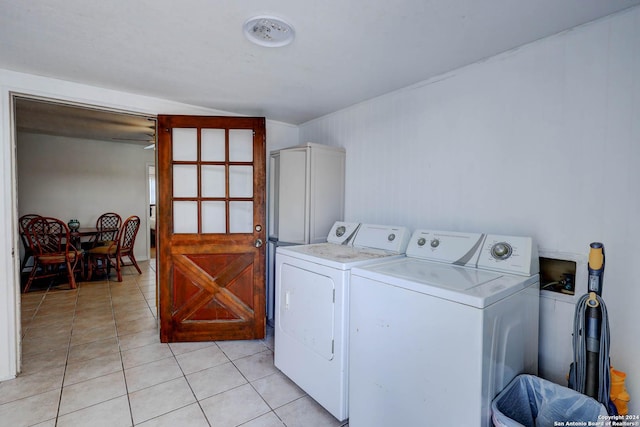 laundry room with light tile patterned floors, laundry area, and washer and dryer