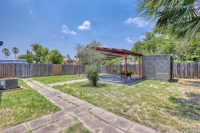 view of yard with central AC unit, a fenced backyard, and a patio area