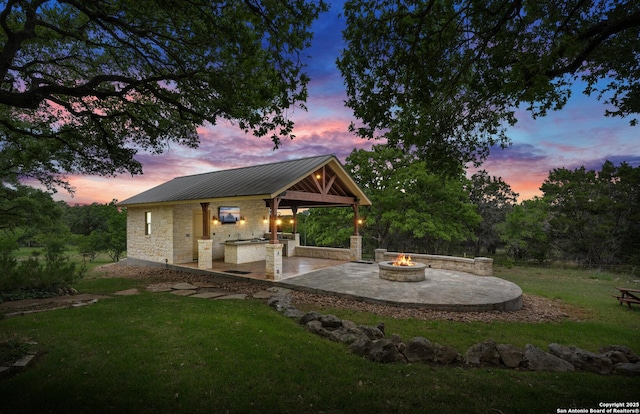 exterior space featuring a gazebo, an outdoor fire pit, a patio area, and area for grilling