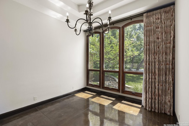 unfurnished dining area featuring baseboards, a tray ceiling, and a chandelier