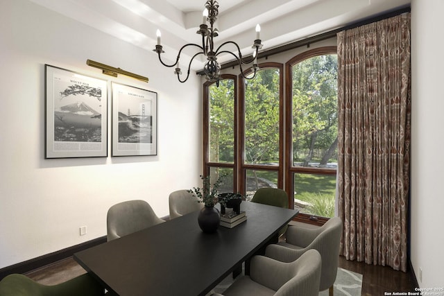 dining area featuring baseboards, wood finished floors, and a notable chandelier