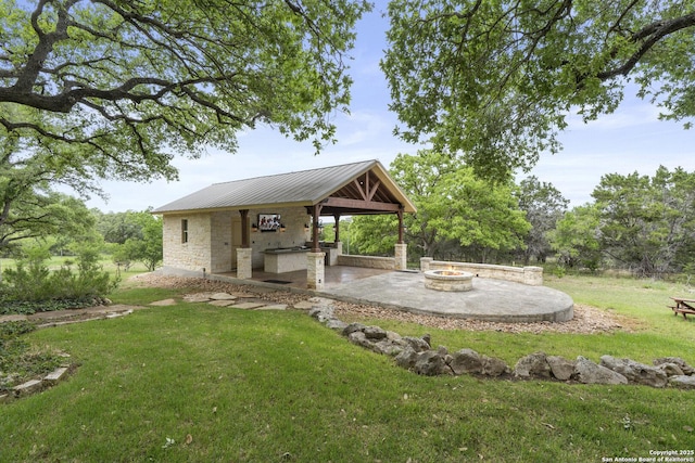 view of yard with a patio and a fire pit